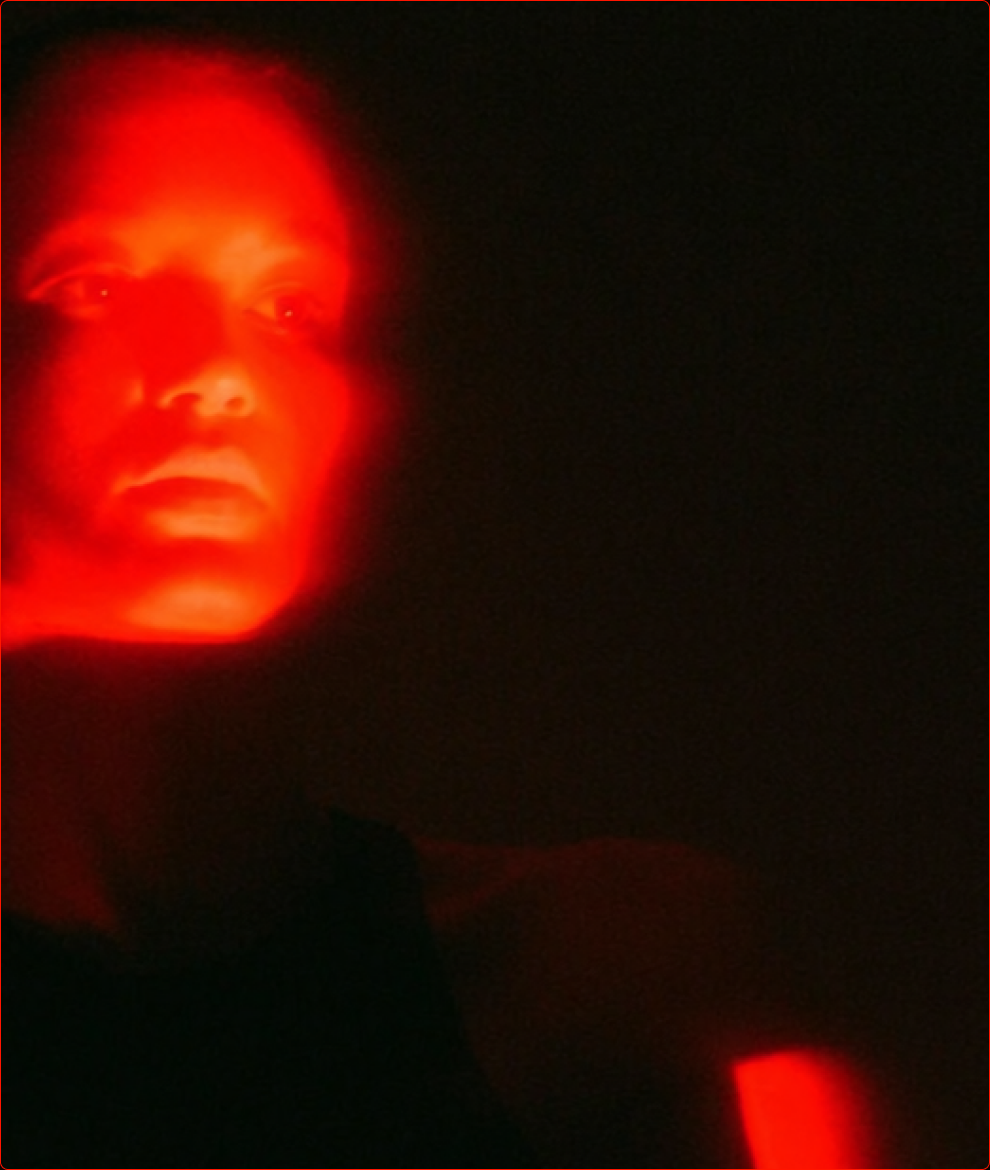 Face lit by red light
