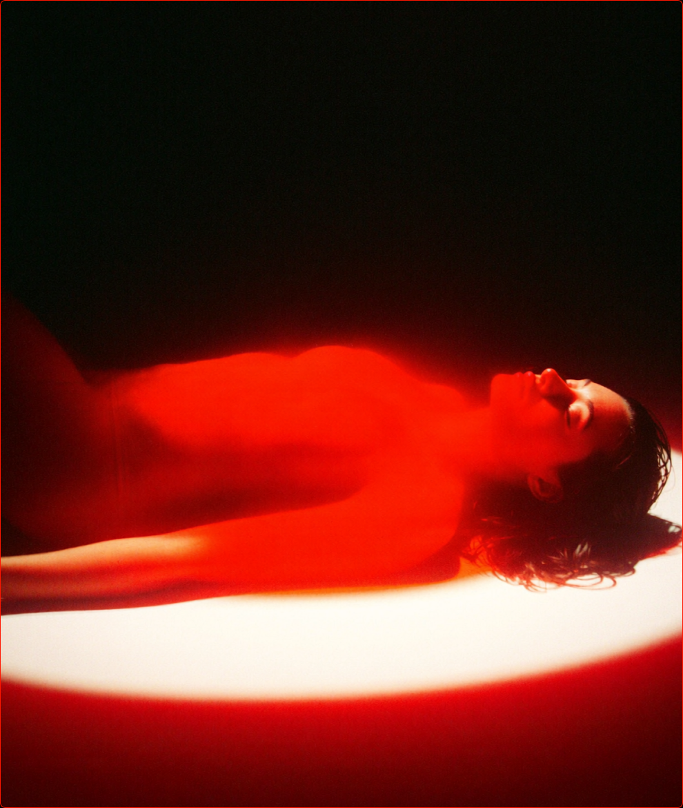 Person resting under red light